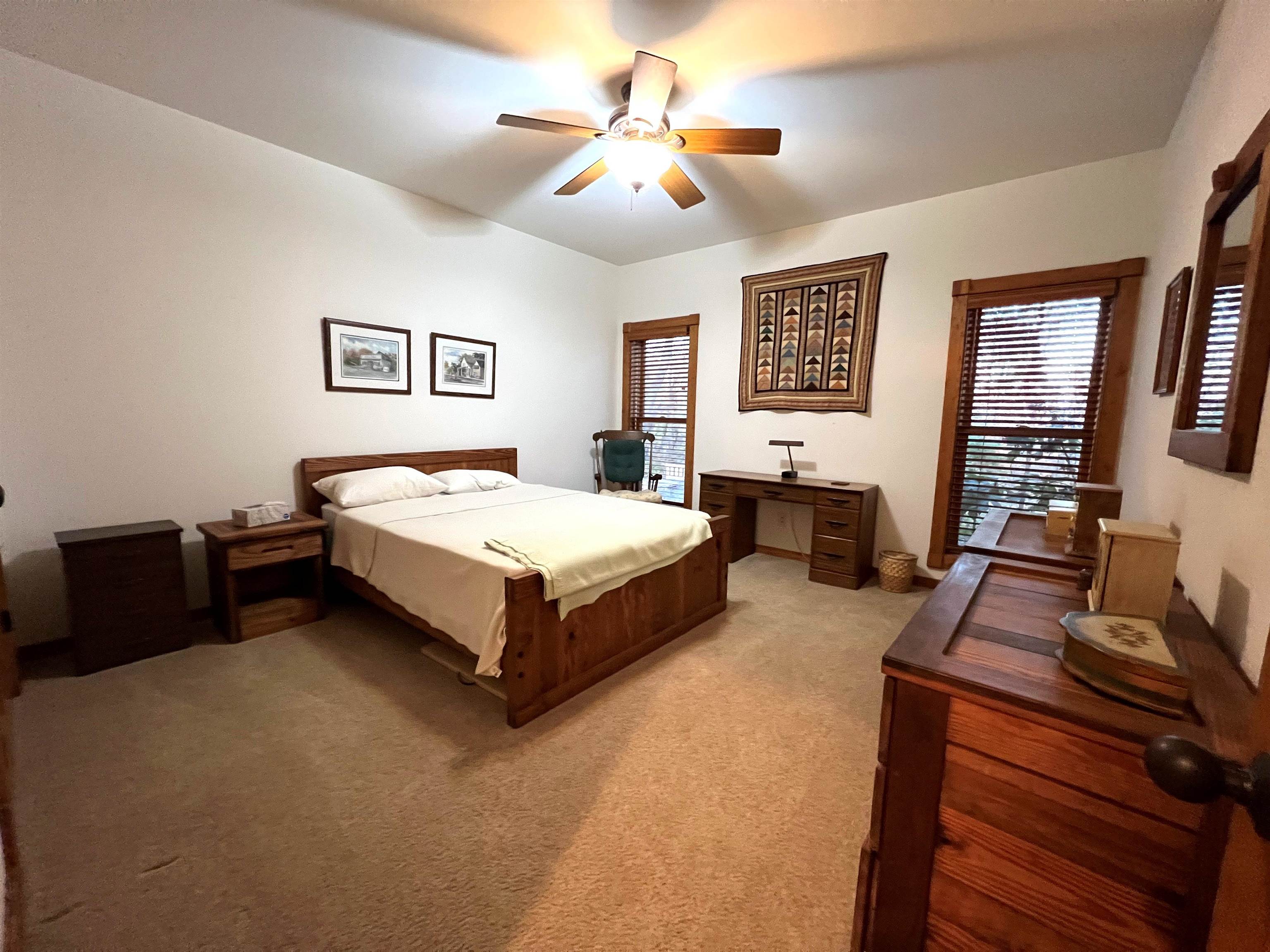 4707 South Elmoville Road Stockton, IL 61085 - Photo 24 of 43 a spacious bedroom with a bed and a couch