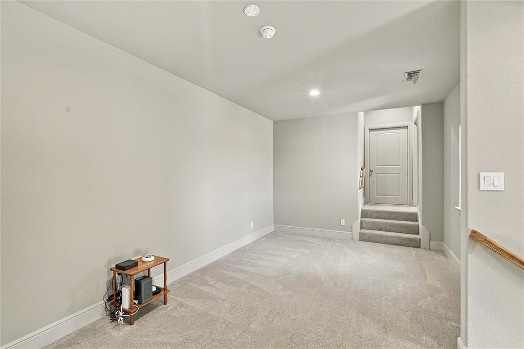 1180 Wiggins Road Maypearl, TX 76064 - Photo 26 of 40 Plush carpet and neutral tones carry through this upstairs hallway, tying the bedrooms together with a warm, cohesive feel.