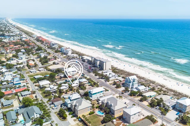 an aerial view of residential building with beach