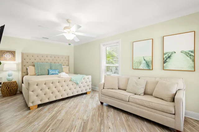 a bedroom with a large bed couch and a window