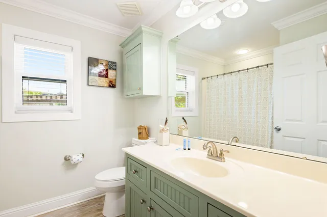 a bathroom with a sink a toilet and a large mirror