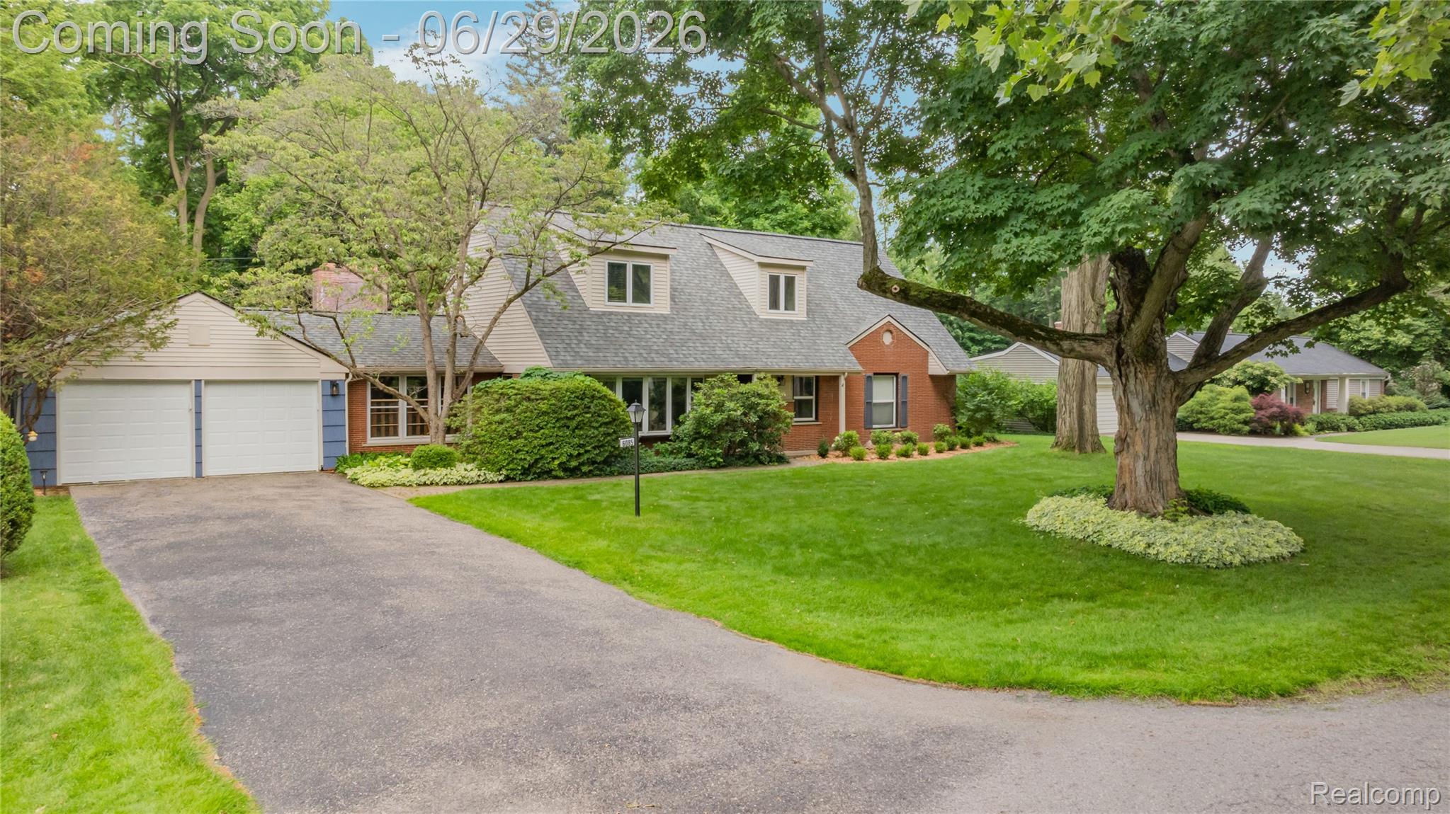 6085 Worlington Road Bloomfield Hills, MI 48301 - Photo 2 of 75 Traditional brick residence with a two-car garage, dormer windows, and a mature tree-lined front yard