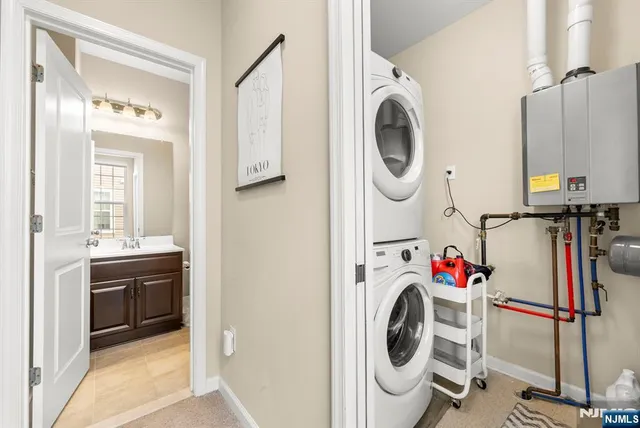 a utility room with dryer washer and a view of bathroom