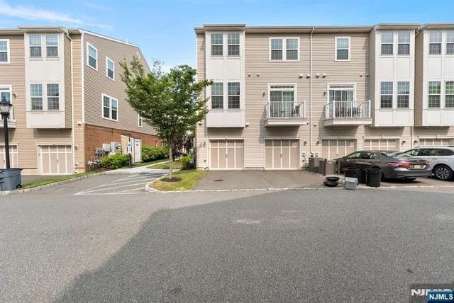 a view of building with car parked on road