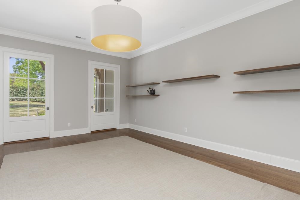 76 Waring Road Memphis, TN 38117 - Photo 7 of 25 an empty room with a window and chandelier