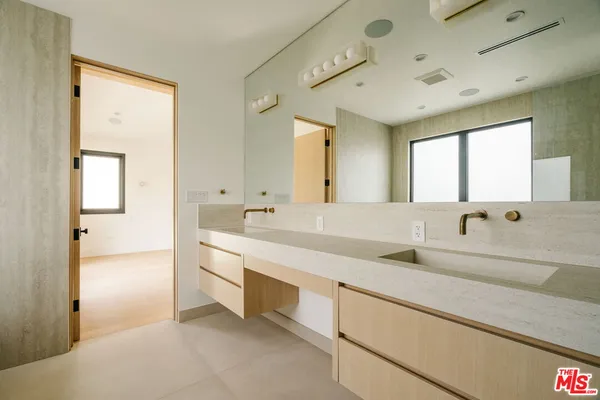 a spacious bathroom with a double vanity sink mirror and double