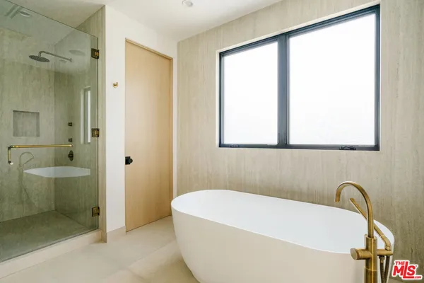 a bathroom with a bathtub and a shower