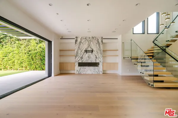 a view of entryway and hall with wooden floor