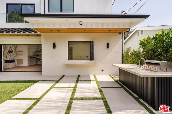 a hallway with a wooden floor and a potted plant