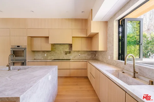 a kitchen with a sink stove and cabinets