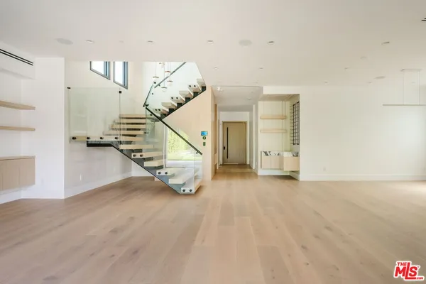 a view of an entryway with wooden floor