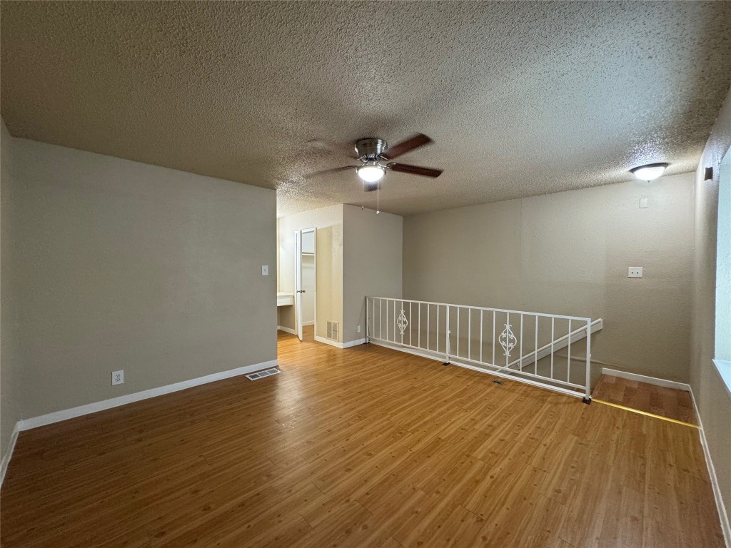 4902 West Wind Trail, Unit 104 Austin, TX 78745 - Photo 11 of 18 a view of an empty room with wooden floor