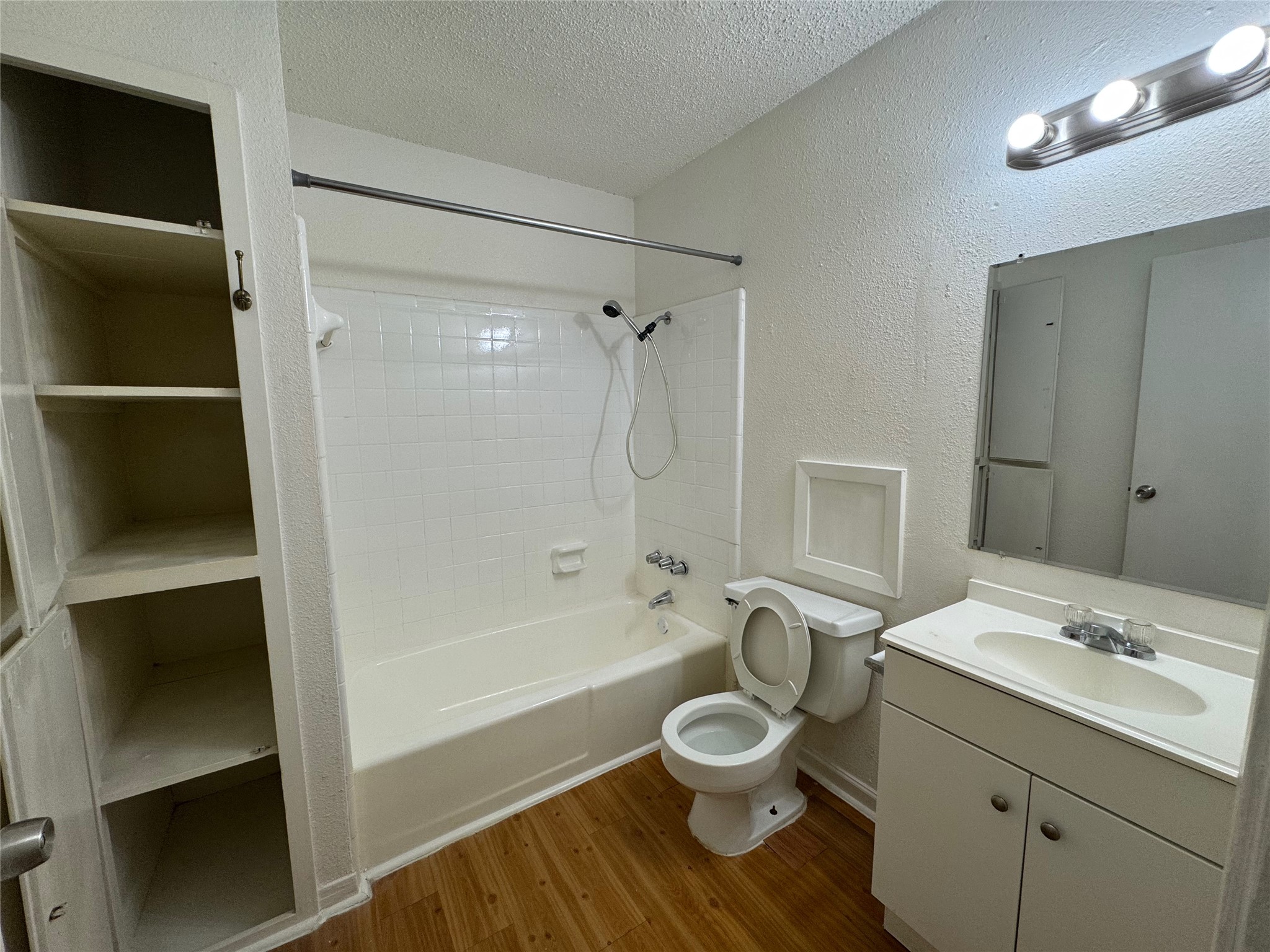4902 West Wind Trail, Unit 104 Austin, TX 78745 - Photo 13 of 18 a bathroom with a sink toilet a shower and bathtub