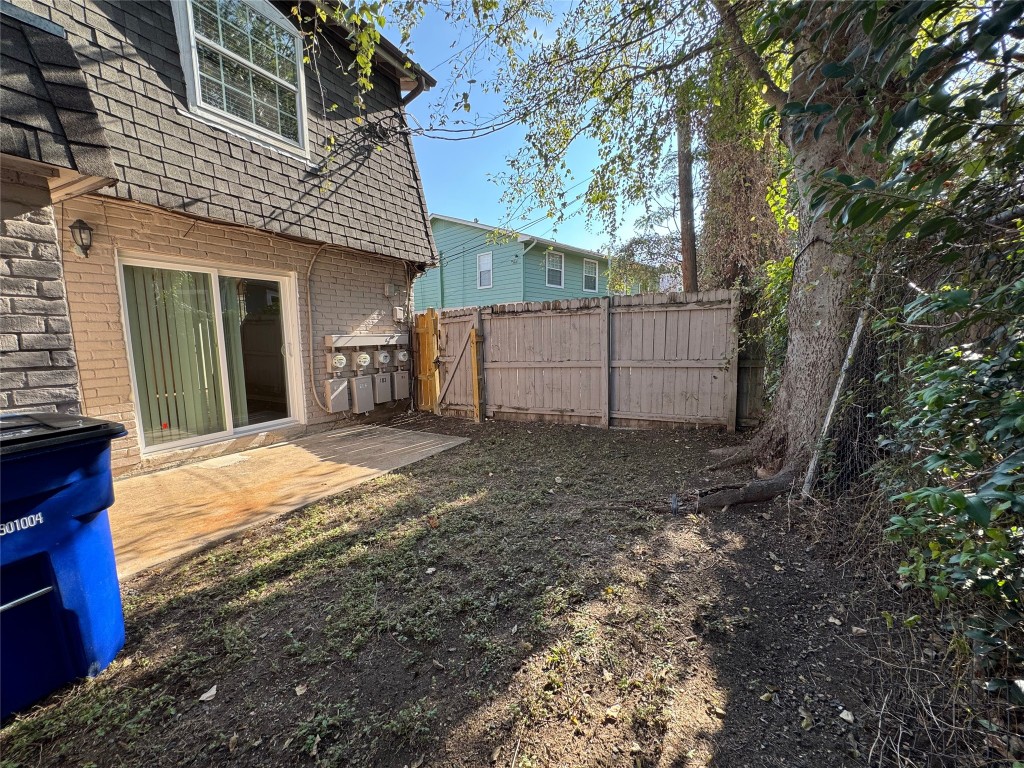 4902 West Wind Trail, Unit 104 Austin, TX 78745 - Photo 17 of 18 a view of a house with a yard and garage