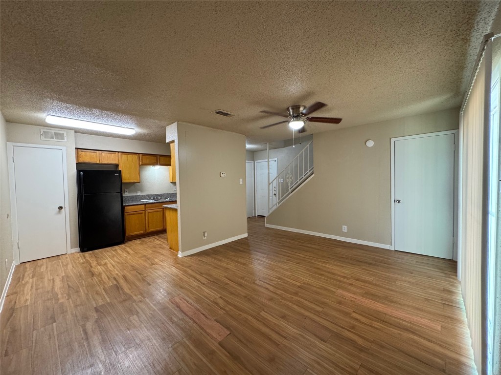 4902 West Wind Trail, Unit 104 Austin, TX 78745 - Photo 3 of 18 a view of a livingroom with a kitchen
