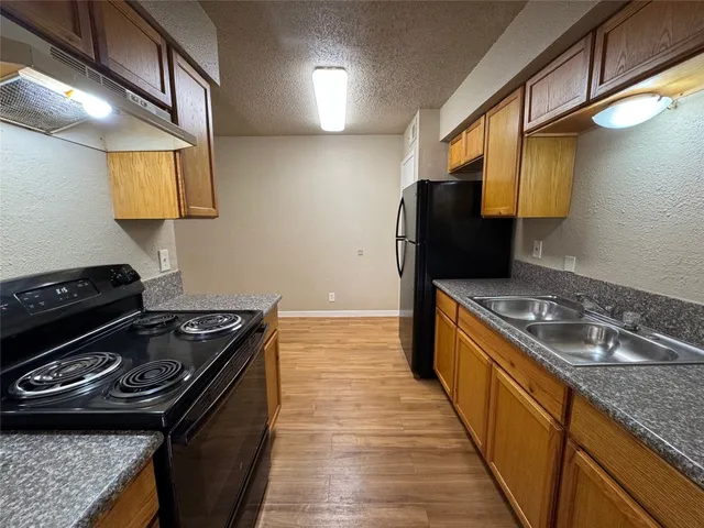 a kitchen with a stove and a sink