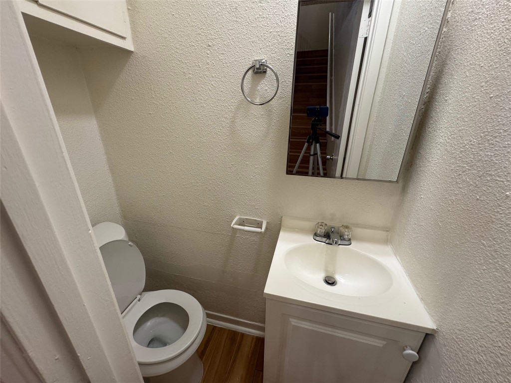 4902 West Wind Trail, Unit 104 Austin, TX 78745 - Photo 7 of 18 a bathroom with a toilet and a sink