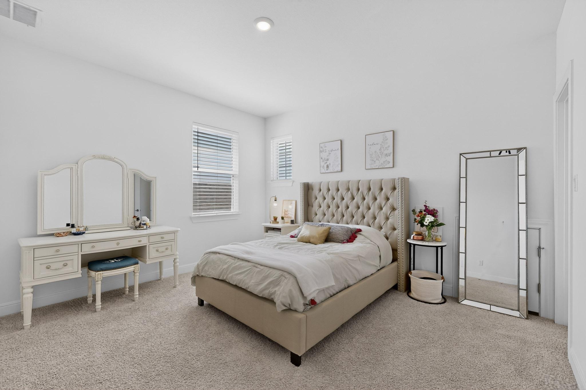 249 Running Bird Road Austin, TX 78737 - Photo 20 of 40 a bedroom with a bed and a window
