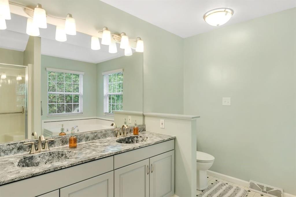 100 Shortcut Road Baden, PA 15005 - Photo 11 of 25 The 4-piece master bathroom features a large vanity with double sinks. The bathtub & shower are reflected in the mirror.