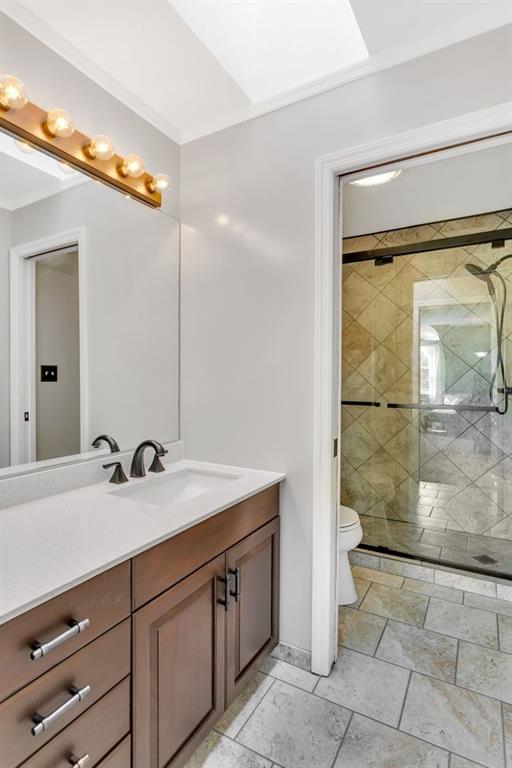 100 Shortcut Road Baden, PA 15005 - Photo 18 of 25 This is full hall bath #2. It was remodeled in 2019. This bathroom features a skylight, ceramic tile floor, a walk in shower with ceramic tile surround and glass enclosure. There is a pocket door separating the toilet/shower from the vanity.