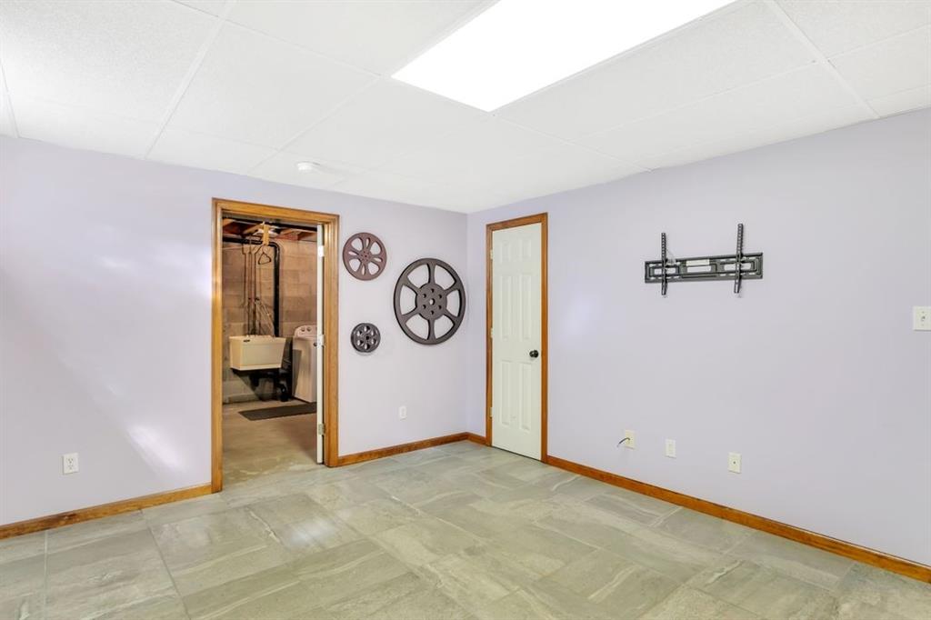 100 Shortcut Road Baden, PA 15005 - Photo 20 of 25 Alternate view of basement level game room. The door on the right is storage under the stairs. The door on the left leads to the laundry/storage area.