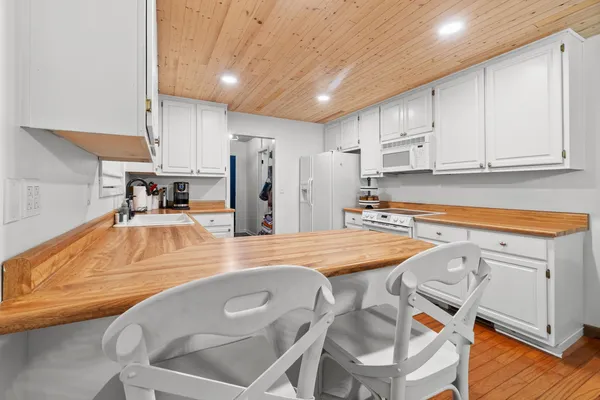 a kitchen with stainless steel appliances granite countertop a sink refrigerator and cabinets