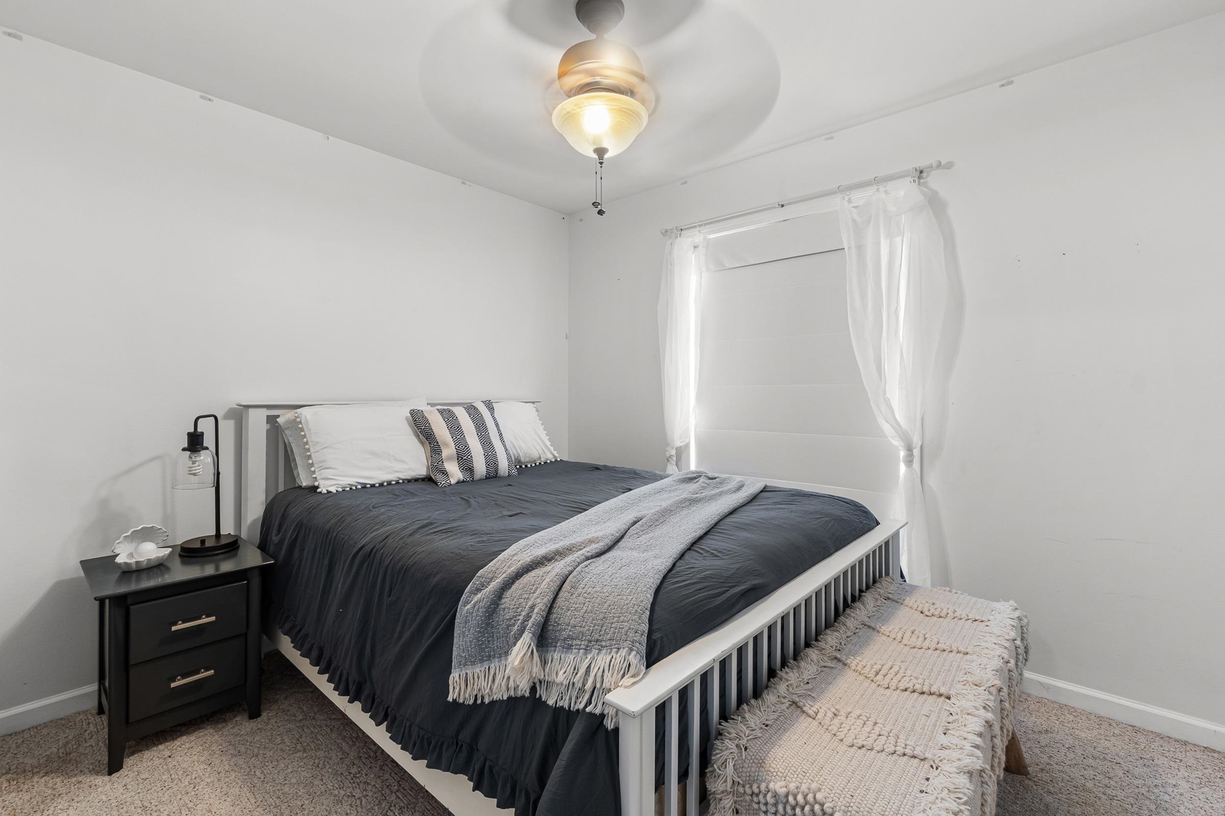 90 Roberts Drive Cherokee, MS 35616 - Photo 24 of 38 a bedroom with a bed and a chandelier