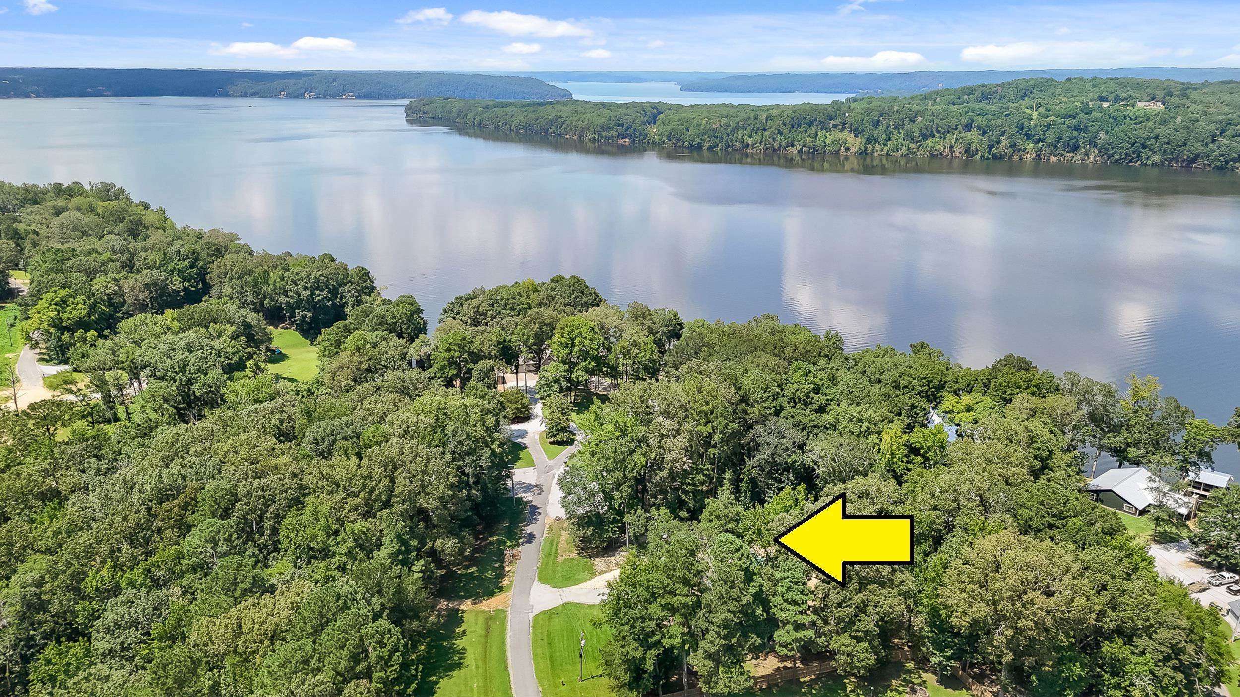 90 Roberts Drive Cherokee, MS 35616 - Photo 31 of 38 a view of a lake with a house in the background