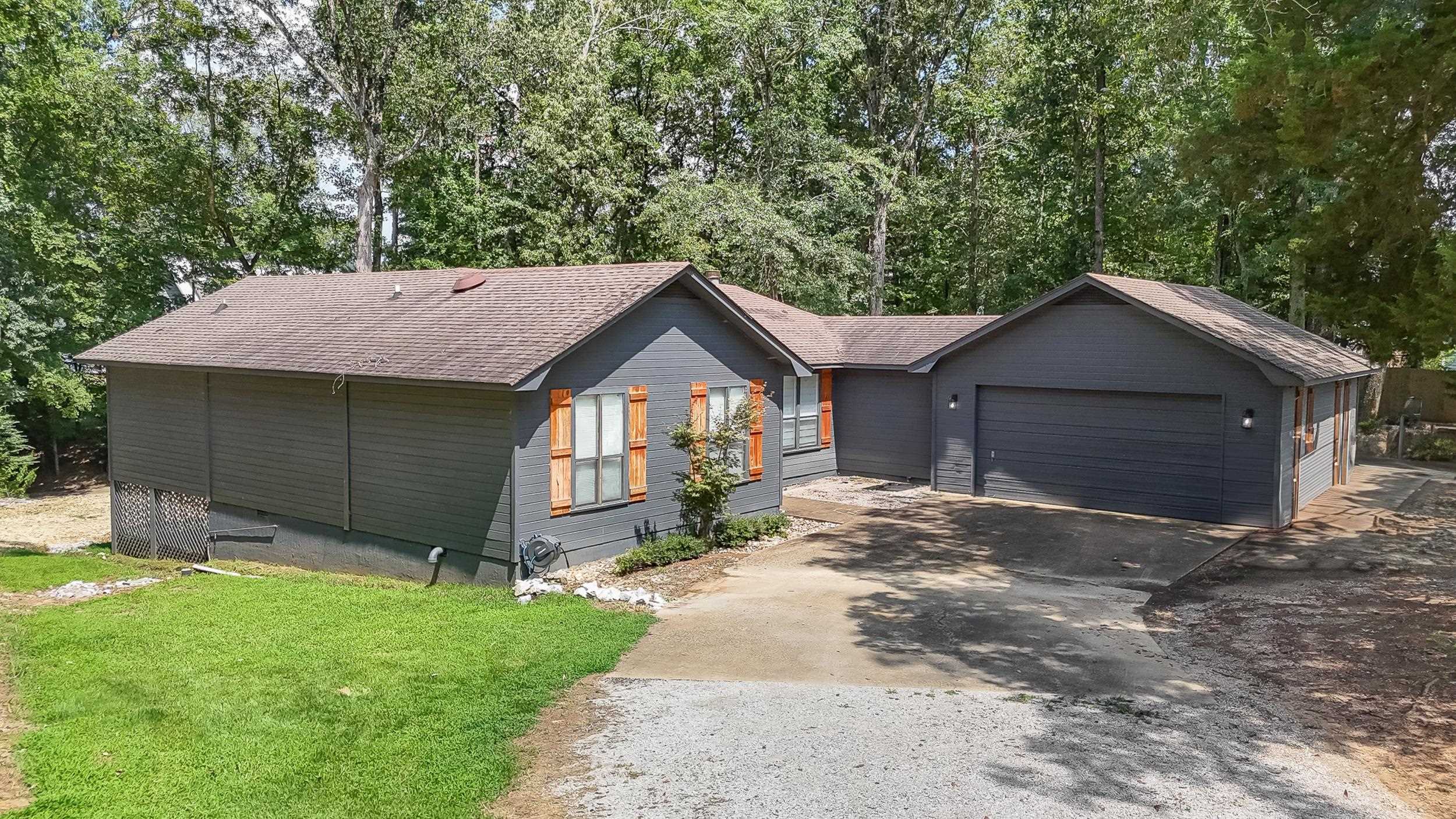 90 Roberts Drive Cherokee, MS 35616 - Photo 32 of 38 a front view of a house with a yard and garage