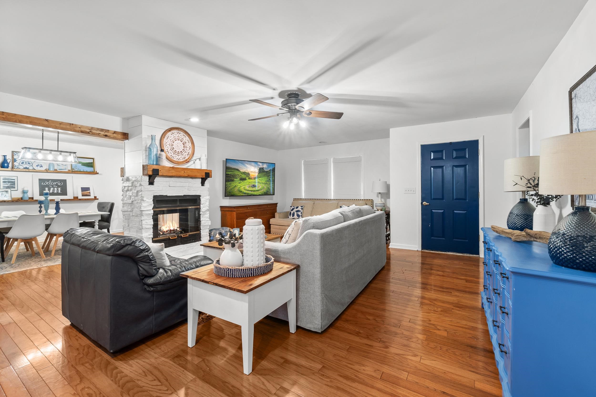 90 Roberts Drive Cherokee, MS 35616 - Photo 9 of 38 a living room with fireplace furniture and a wooden floor