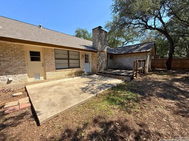 a backyard of a house with table and chairs