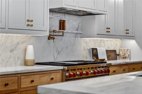 a large kitchen with kitchen island a sink stainless steel appliances and cabinets