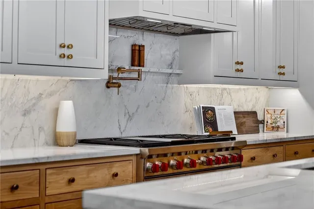 a large kitchen with kitchen island a sink stainless steel appliances and cabinets