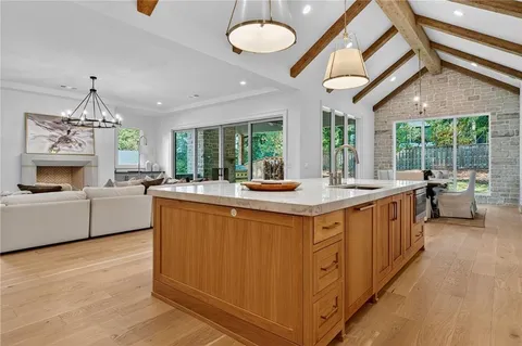 a kitchen with stainless steel appliances granite countertop a lot of counter space and windows