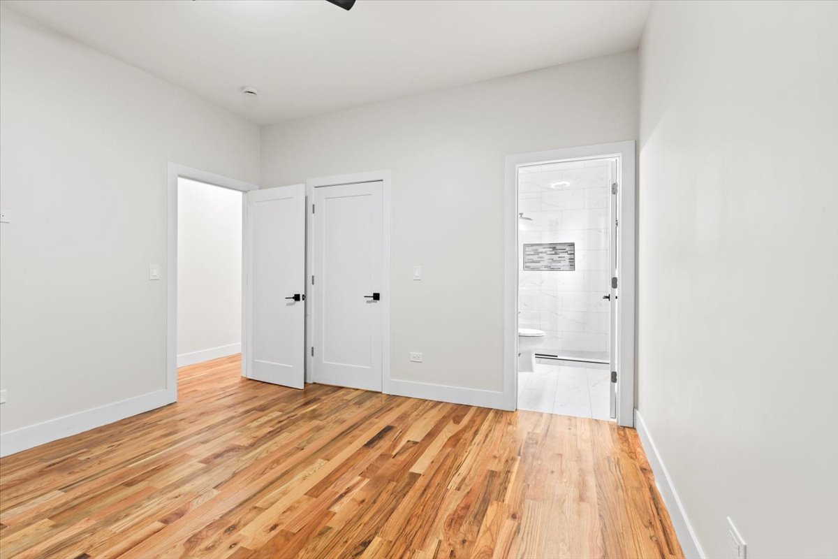 6128 South Rhodes Avenue, Unit 2 Chicago, IL 60637 - Photo 11 of 12 wooden floor in an empty room