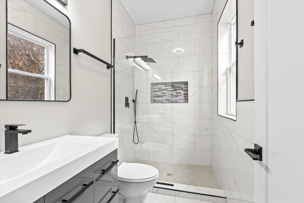 6128 South Rhodes Avenue, Unit 2 Chicago, IL 60637 - Photo 12 of 12 a bathroom with a sink a toilet and shower