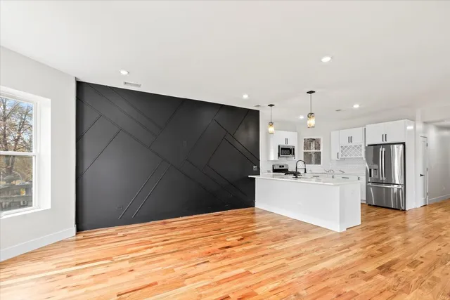 a kitchen with a refrigerator and a stove top oven