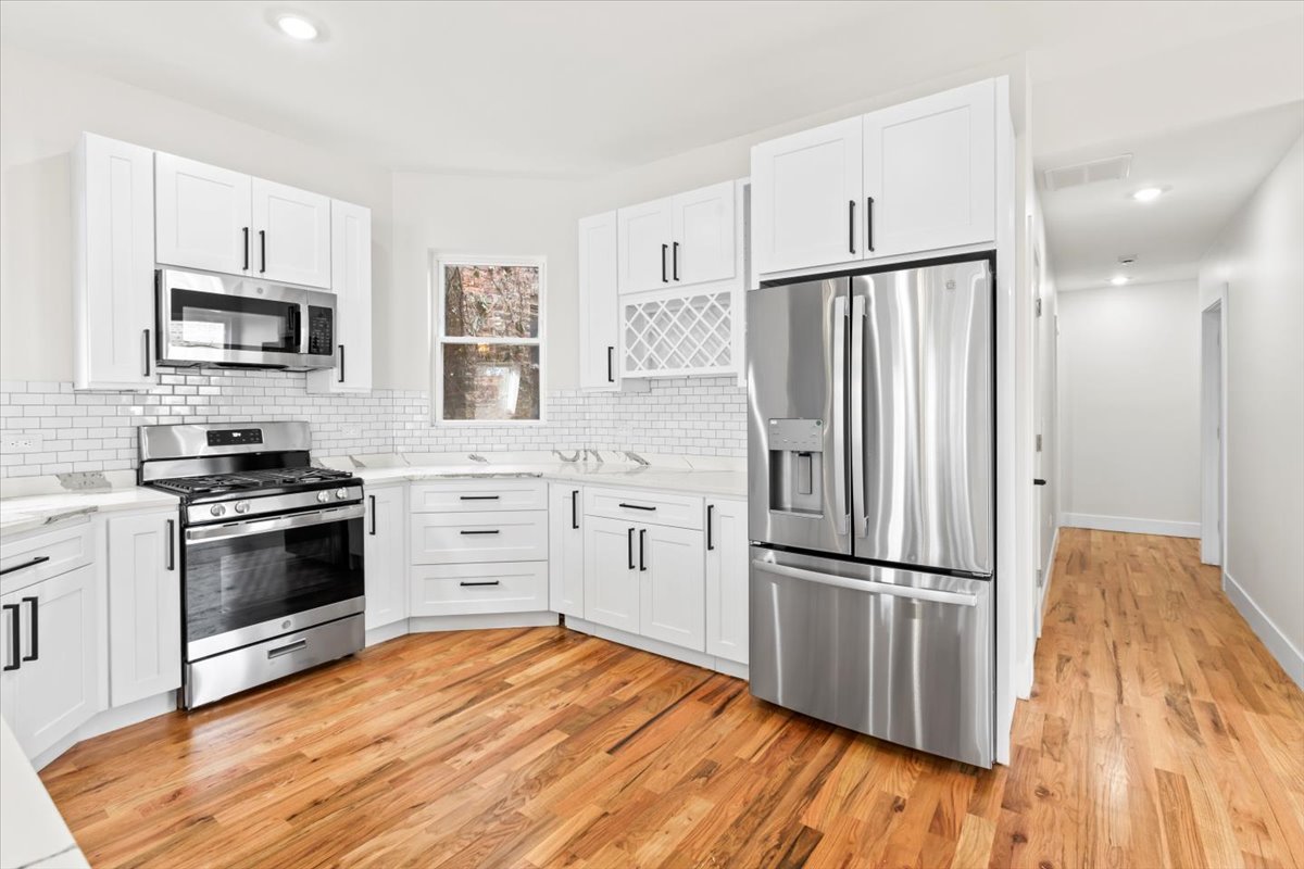 6128 South Rhodes Avenue, Unit 2 Chicago, IL 60637 - Photo 6 of 12 a kitchen with stainless steel appliances a refrigerator stove and microwave