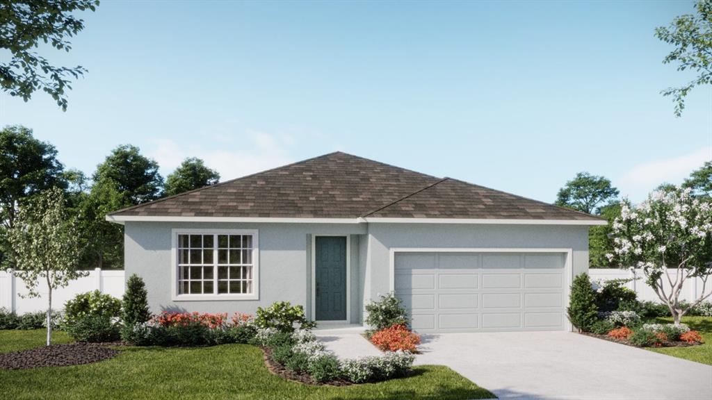 6146 Success Way St. Cloud, FL 34771 - Photo 1 of 6 a front view of a house with garden