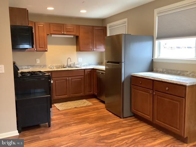 a kitchen with granite countertop stainless steel appliances and wooden cabinets