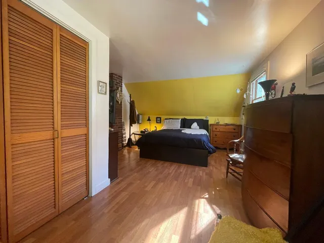 a bedroom with a bed and a television