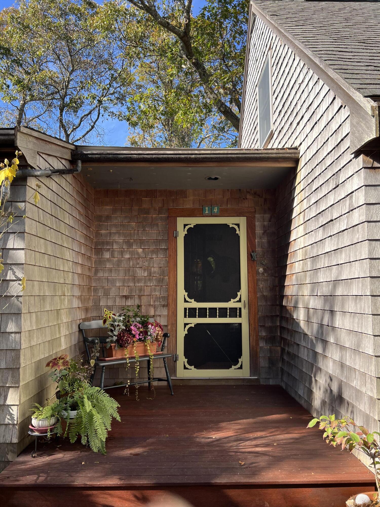 14 21st Street North Edgartown, MA 02539 - Photo 3 of 19 a side view of a fireplace with a potted plant