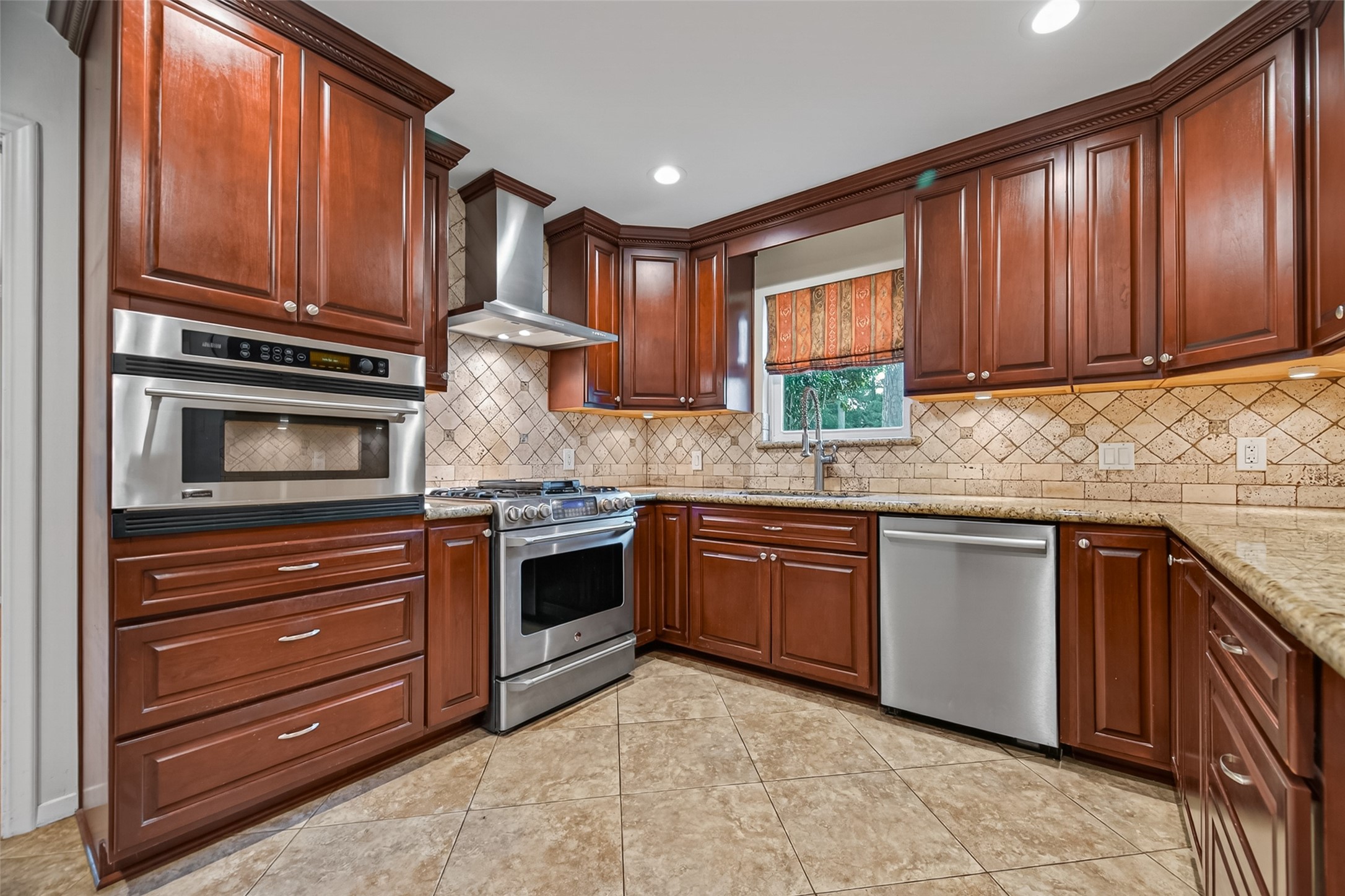 5638 Sanford Road Houston, TX 77096 - Photo 12 of 41 Kitchen features a gas range with electric oven and a sink with side yard views.