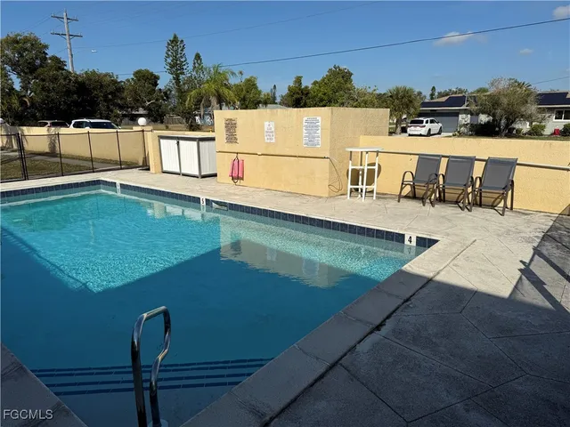 a view of a swimming pool with chairs