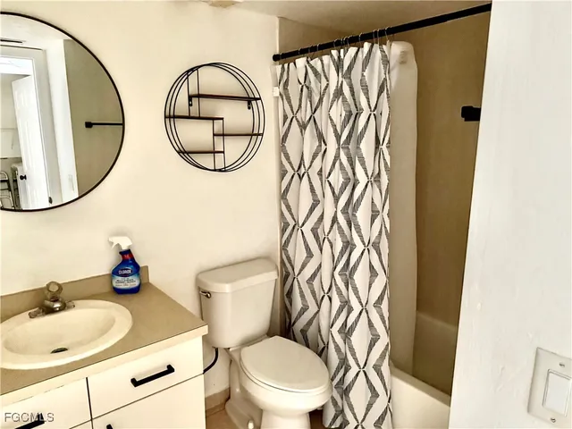 a bathroom with a toilet a sink and a mirror