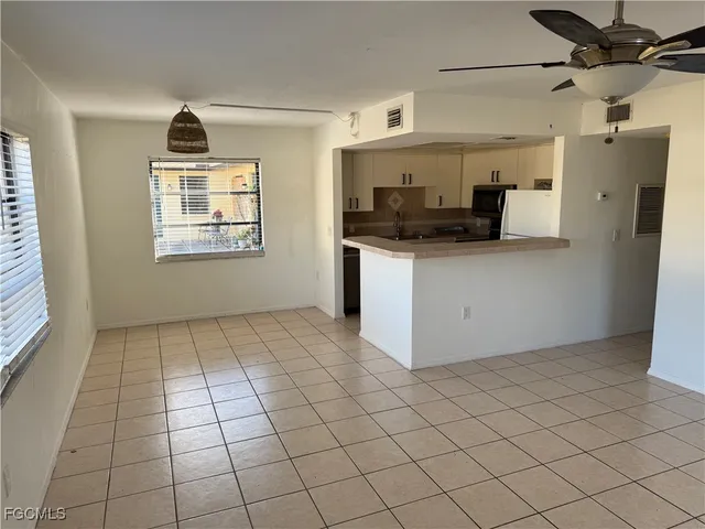 a kitchen with granite countertop white cabinets and stainless steel appliances