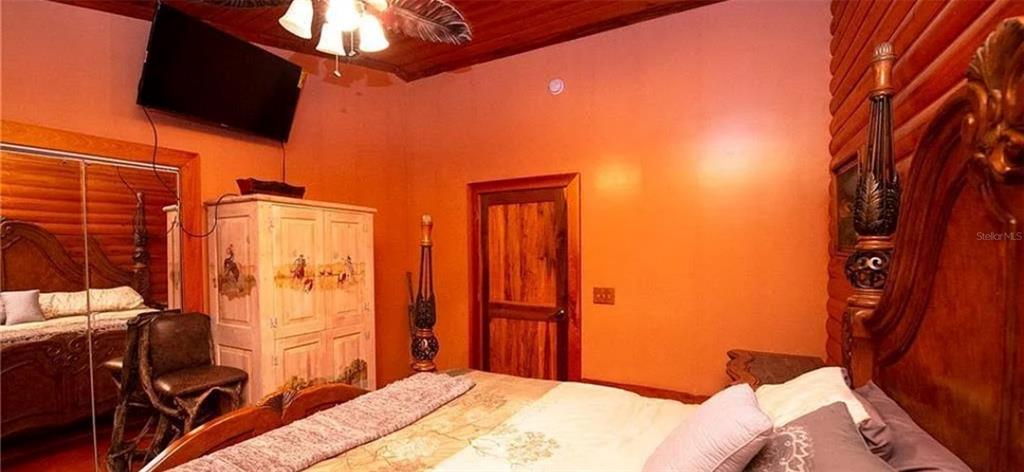 13255 Highway 441 Okeechobee, FL 34974 - Photo 18 of 29 a bedroom with a bed and wooden floor