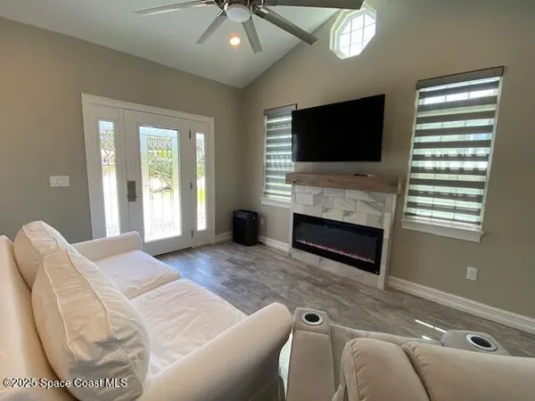 a living room with furniture fireplace and a flat screen tv