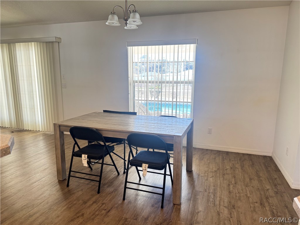 4588 East Van Ness Road Inverness, FL 34453 - Photo 7 of 34 an empty room with wooden floor and furniture