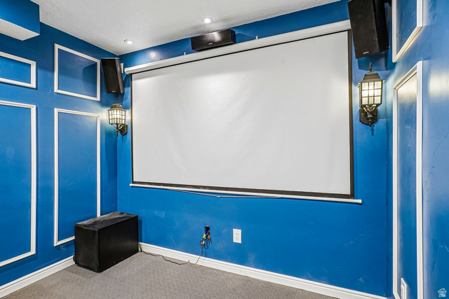 203 North 1900th Street West Mapleton, UT 84664 - Photo 26 of 48 Projector screen installation complemented by built-in wall speakers, wall sconces, recessed lighting, and decorative wall molding